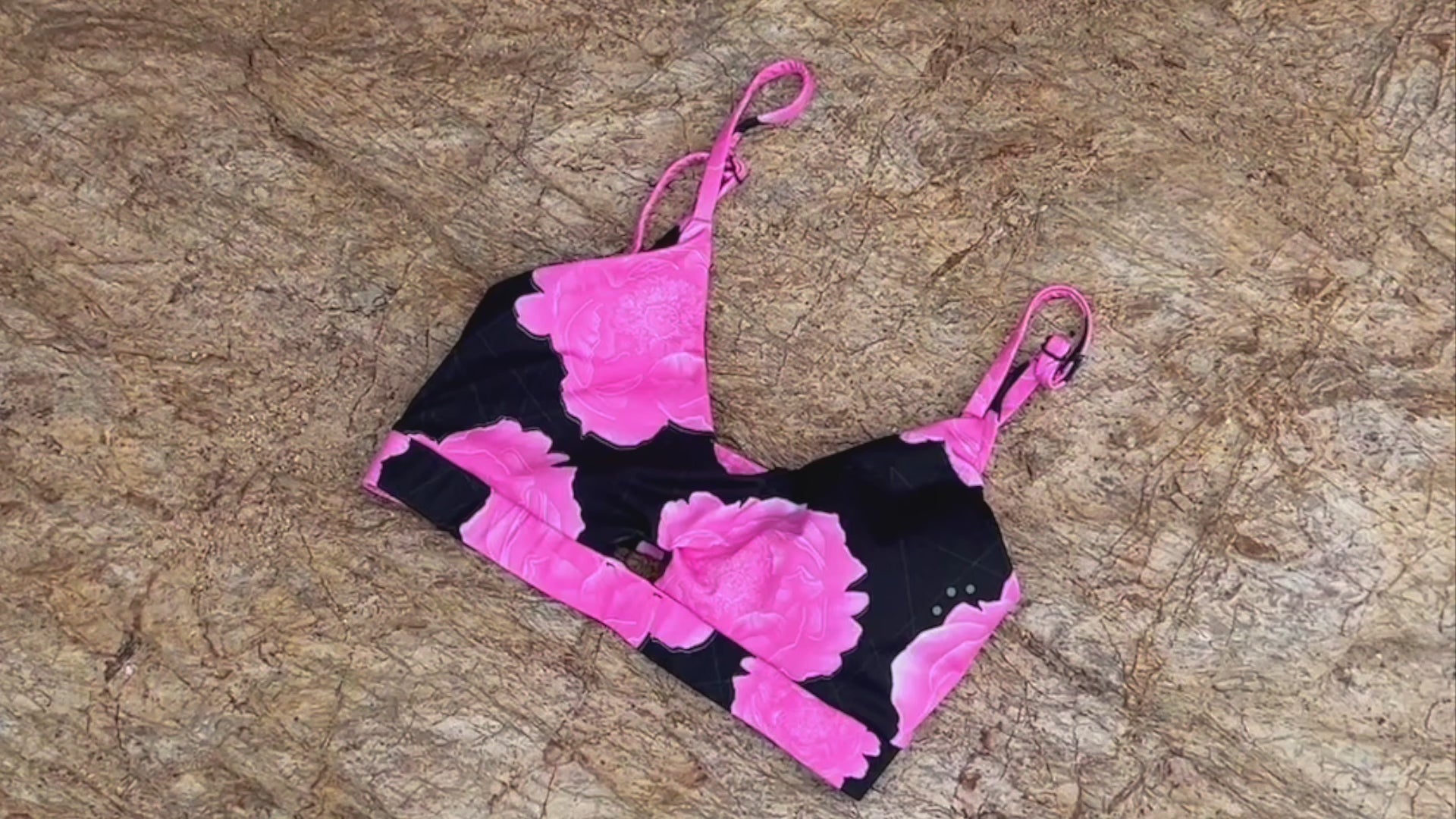 Load video: woman wearing a pink floral sports bra